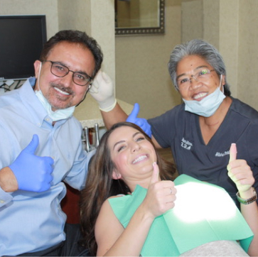 Doctors smiling with happy patient